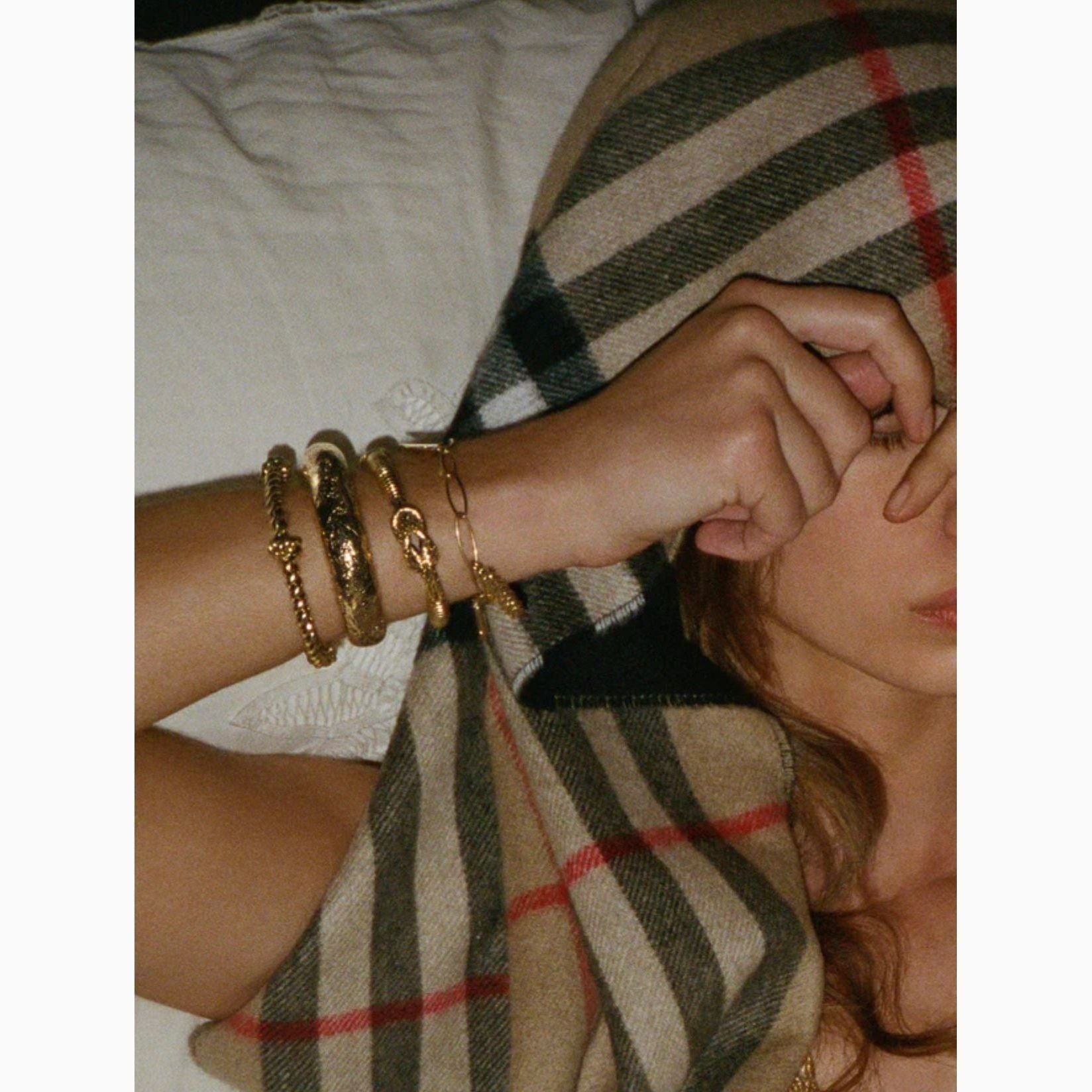 Model wearing Aurelie Bidermann jewelry arm stack bangles