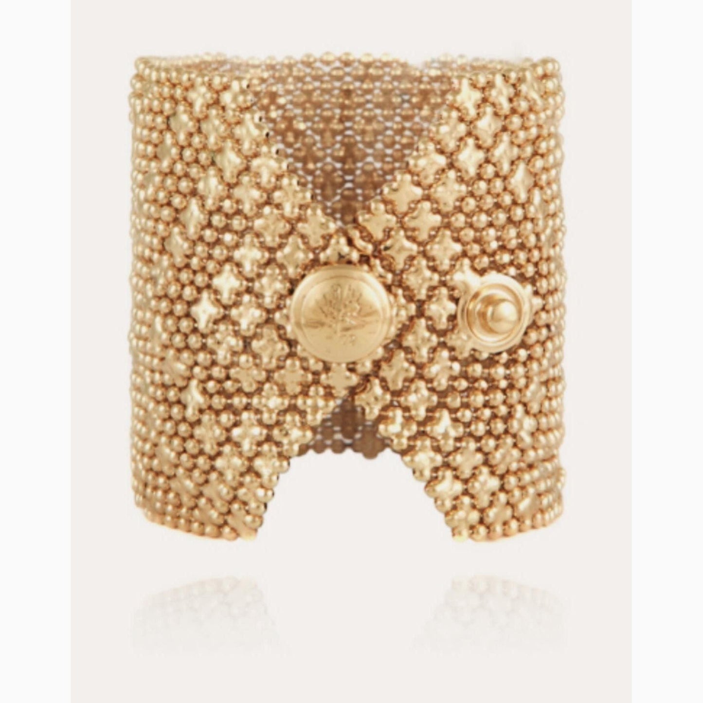 Introducing the stunning Gas Bijoux 24k gold-plated cuff, adorned with multiple chains and star-shaped accents.