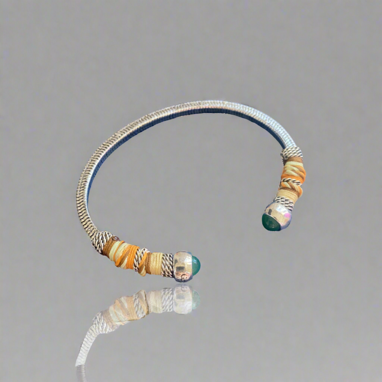 This adjustable bangle offers both style and versatility, with a width of 0.7cms and a circumference of 16.5cms. Elevate your wrist with this exquisite piece, perfect for adding a touch of artisanal charm to any ensemble.