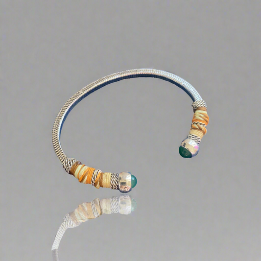 This adjustable bangle offers both style and versatility, with a width of 0.7cms and a circumference of 16.5cms. Elevate your wrist with this exquisite piece, perfect for adding a touch of artisanal charm to any ensemble.