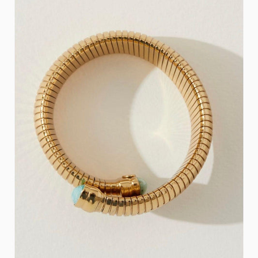 Gold plated bracelet composed of a flexible mesh adorned with Antigone gemstones cabochons. Width: 4 cm - Circumference: 18 cm Weight: 60 g