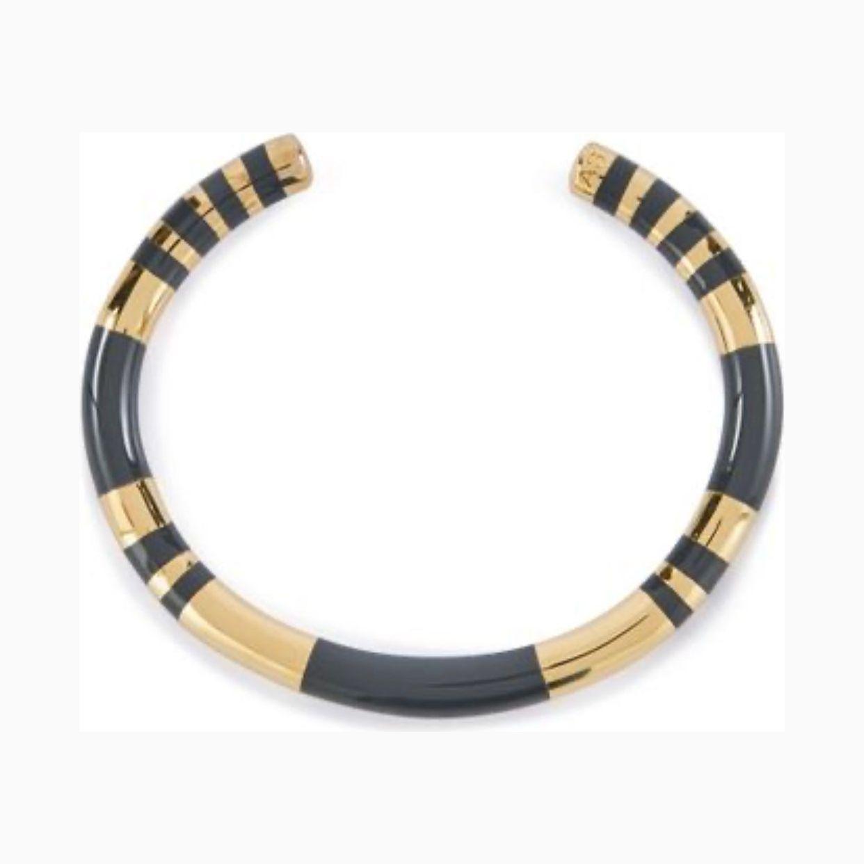 Elevate your style with the Aurèlie Bidermann Positano two-tone grey resin and gold bangle, featuring a chic combination of resin and gilded 750/1000 yellow gold.