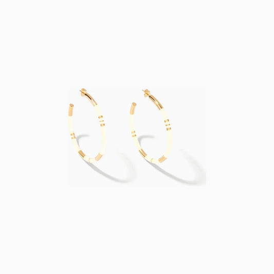 Level up your style with the Aurélie Bidermann Positano Creoles, featuring ivory-colored stripes in resin and gilded with 750/1000 yellow gold.