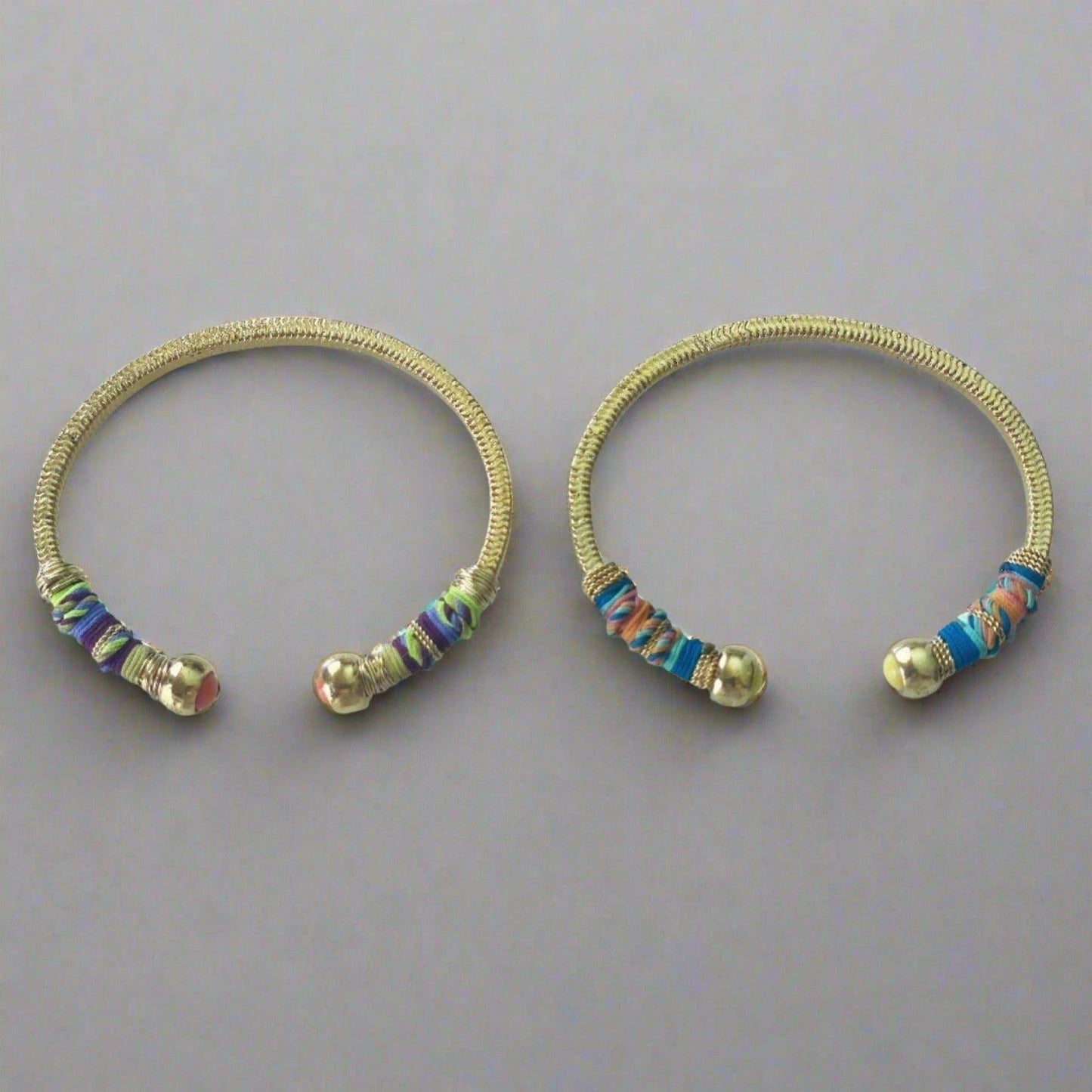 Gold plated bracelet embellished with tinted threads and gold plated chains.  The bracelet is adorned with glass beads at ends. Adjustable size.  Product Details  Yellow Gold Plated Cotton Rope or all metal Width: 0,6 ; Circumference: 14,5 cm