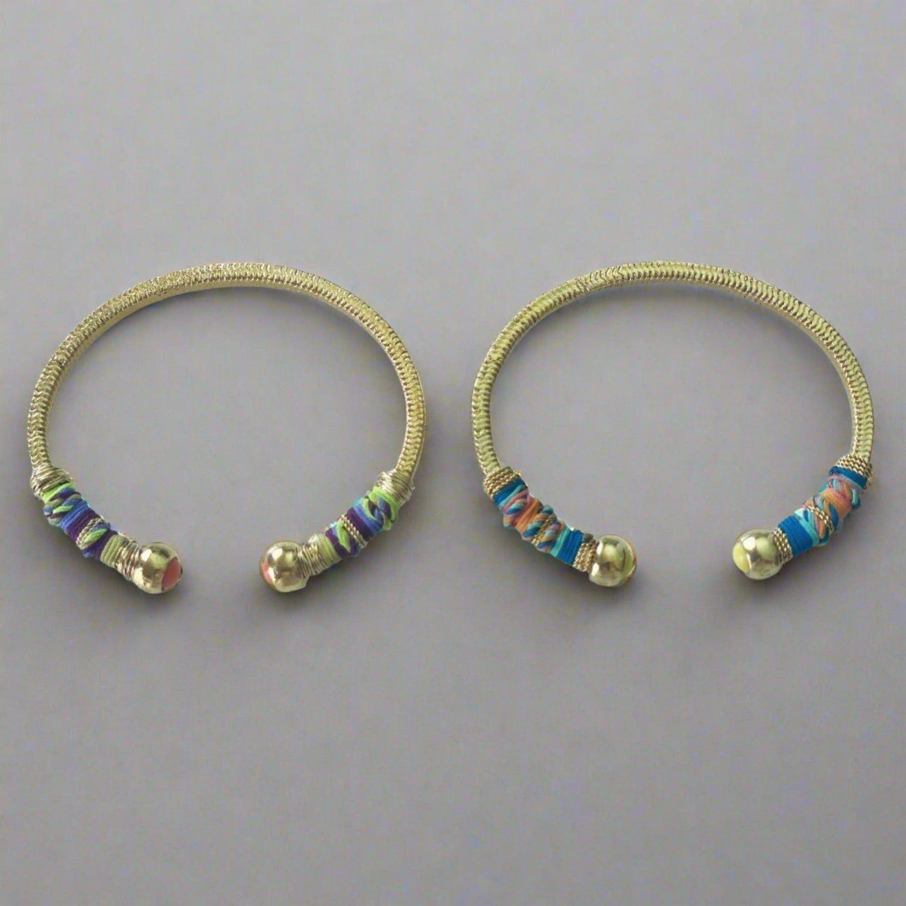 Gold plated bracelet embellished with tinted threads and gold plated chains.  The bracelet is adorned with glass beads at ends. Adjustable size.  Product Details  Yellow Gold Plated Cotton Rope or all metal Width: 0,6 ; Circumference: 14,5 cm