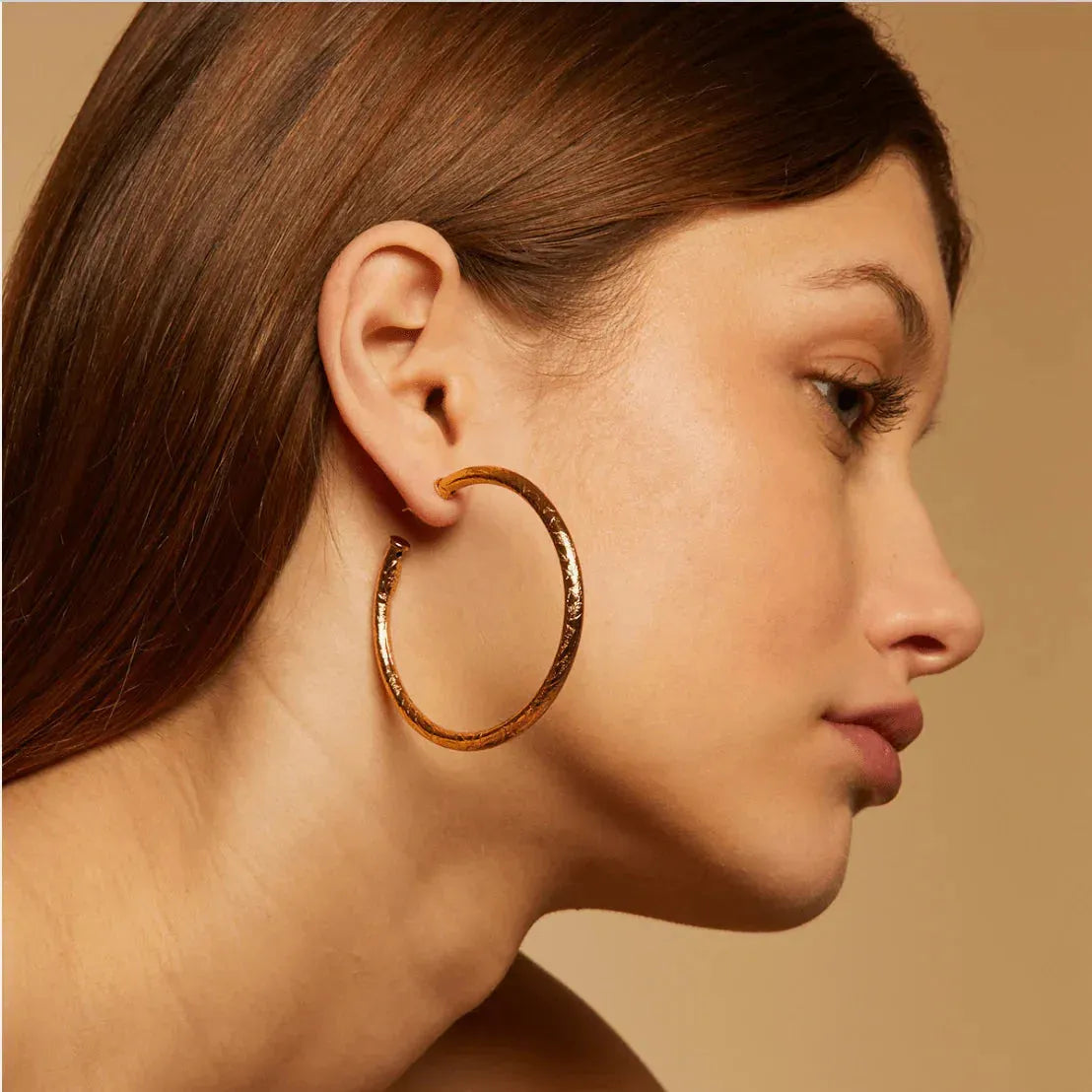 Model wearing Gas Bijoux Maoro Hoops in gold plated